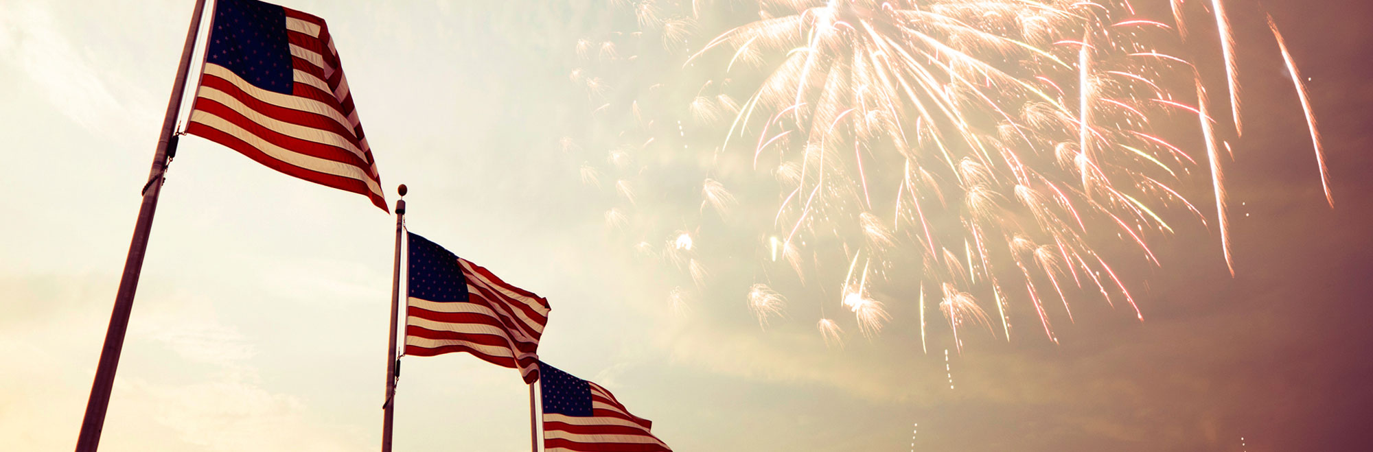 American flags waving in front of fireworks